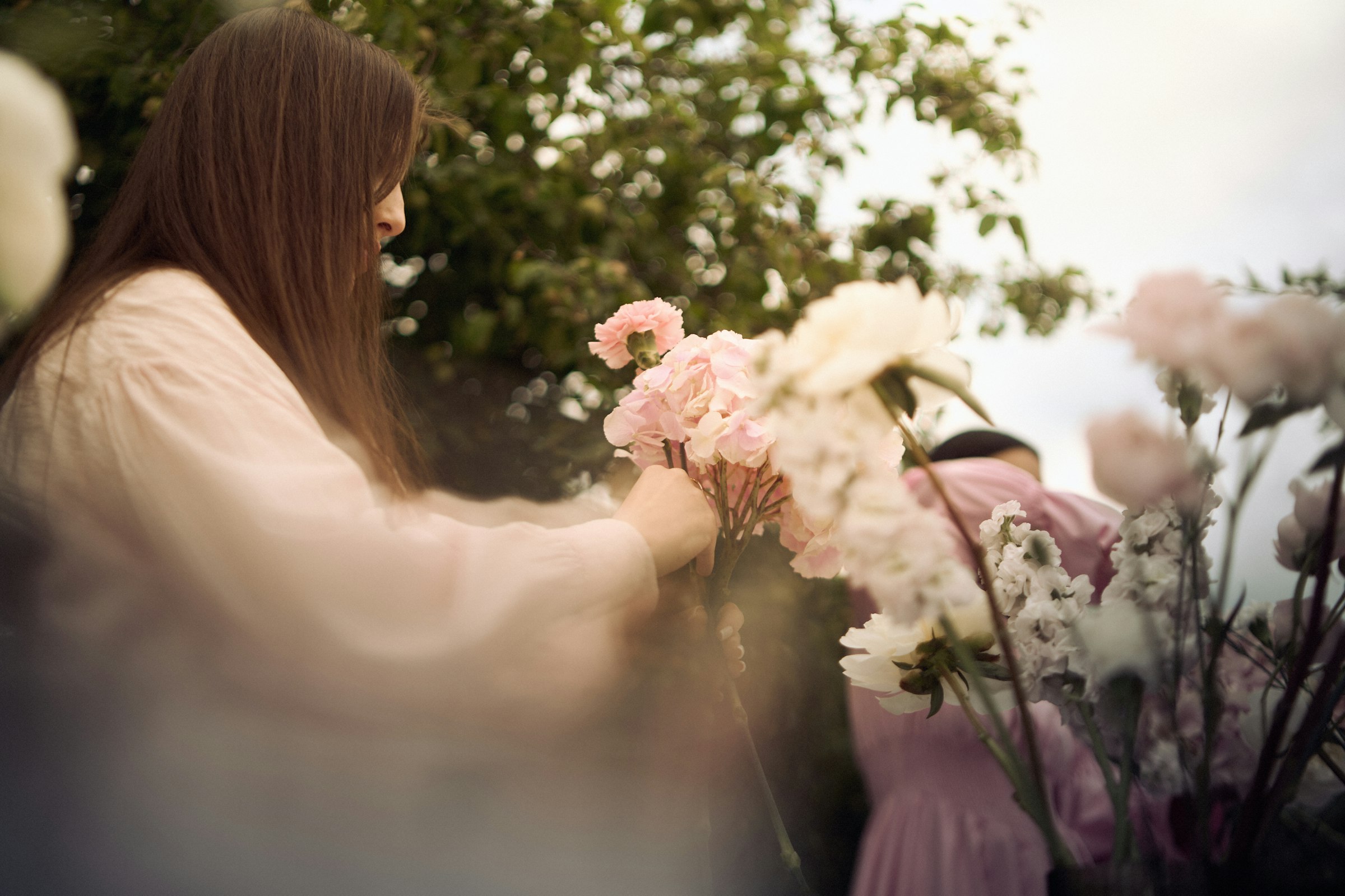 Florist arranging soft pink roses